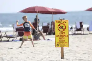A sewage contamination sign is posted in Coronado on June 29. (Sandy Huffaker/For the San Diego Union-Tribune)